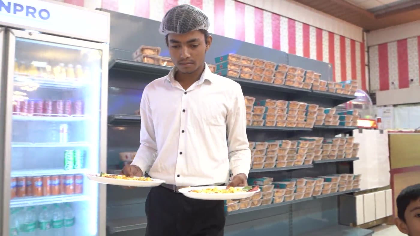 Bakery and sweets chiller stocked with cakes, pastry and mithai boxes