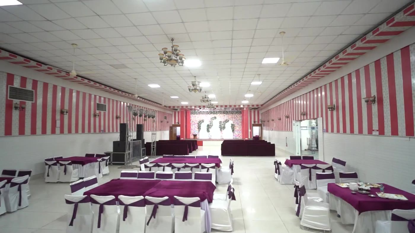 Round tables and draped chairs laid out inside the hall