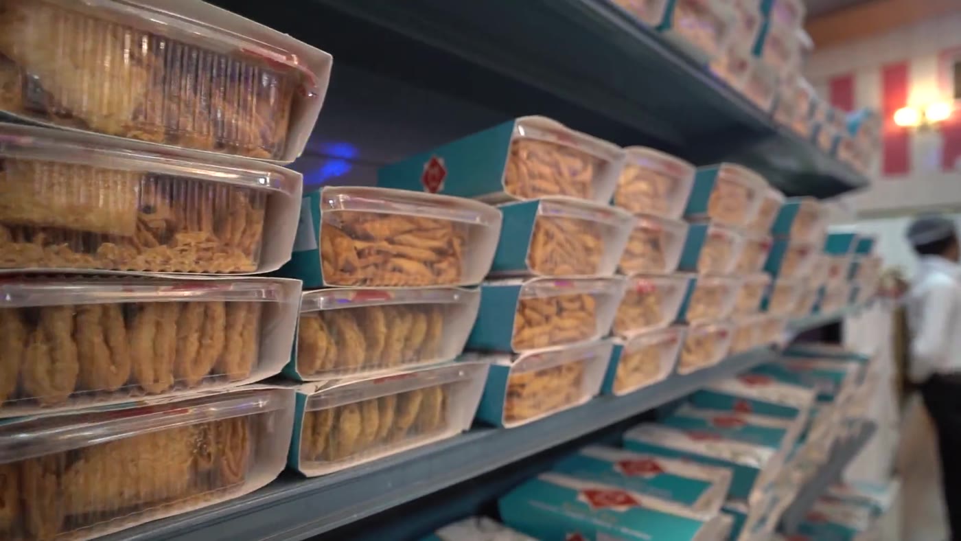 Shelves of packed namkeen, mathhi and snacks at the sweets counter